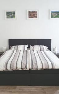 ein Bett mit gestreifter Decke in einem Schlafzimmer in der Unterkunft H-Apartment 2 in Triberg