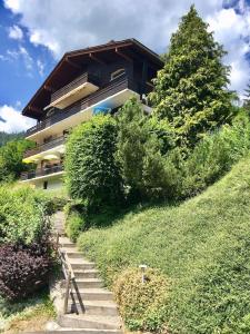 a staircase leading up to a building on a hill at Bel appartement avec vue exceptionnelle in Le Grand-Bornand