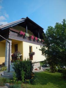 a house with flower boxes on a balcony at Apartment Ana in Ljubno