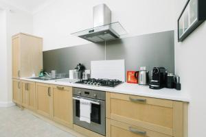 a kitchen with a stove and a counter top at Great location! Heart of City Centre 3bed apartment in Edinburgh