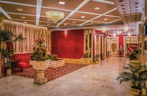 a lobby with red walls and plants in a building at Park Ocean in Jaipur