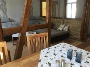 a living room with a table and a couch at Ferienwohnungen An der Bimmelbahn Wernigerode in Wernigerode