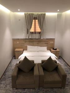 Ένα ή περισσότερα κρεβάτια σε δωμάτιο στο Hala Onaizah +24 φωτογραφίες