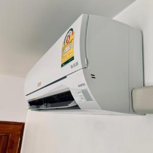a printer is on top of a refrigerator at Chaweng best hotel and hostel samui in Chaweng
