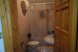 a bathroom with a toilet and a shower and a sink at Appartamento Il Campanile in Muro Leccese +26 photos