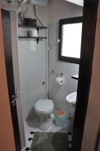 a small bathroom with a toilet and a sink at Anemos - Holiday Beach Houses in Keratokampos