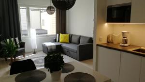 a living room with a couch and a table at Feels like Home City Holvi in Jyväskylä