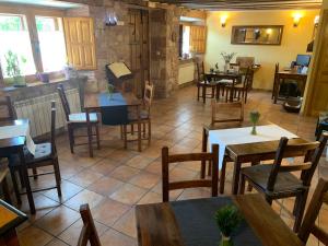 a dining room with tables and chairs in a restaurant at La Cabala de Ibeas in Ibeas de Juarros