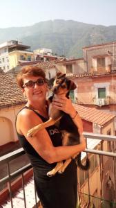 a woman holding a dog in her arms at BUTTERFLY in Castellammare di Stabia