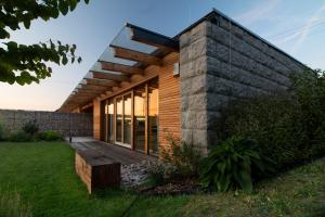 a modern house with a brick wall and a deck at Charming house@LK-living in Liberec