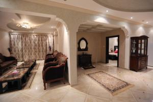 a living room with a couch and a table at Mandareen Al Sharq Serviced Apartments in Az Zulfi