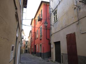 an alley between two buildings in a city at CASA ROSSA in Borgomaro +4 photos