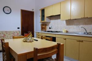 a kitchen with a table and a sink and a stove at CASA TERRE BAROCCHE in Modica