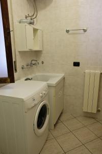 a bathroom with a washing machine and a sink at CASA TERRE BAROCCHE in Modica