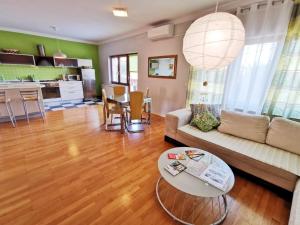 a living room with a couch and a table at Apartment Arena Zagreb in Zagreb