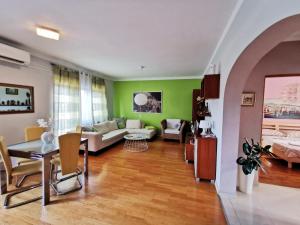 a living room with a couch and a table at Apartment Arena Zagreb in Zagreb