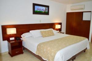 Postel nebo postele na pokoji v ubytování Hotel Hacaritama Colonial