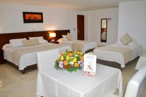 Postel nebo postele na pokoji v ubytování Hotel Hacaritama Colonial