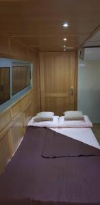 a bedroom with two beds in a small room at Free Room Boat Apartment in Belgrade +36 photos