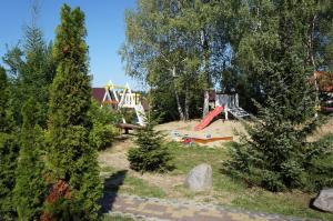 a park with a playground with a slide and trees at PokojeKajaki DD Swornegacie in Swornegacie 
