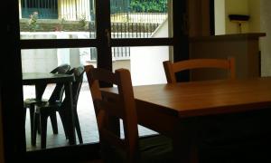 a table and chairs in a room with a window at Idealodge B&B in Colleferro