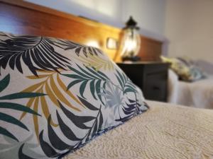 a pillow sitting on a bed in a bedroom at LA ALDEA in Llanes