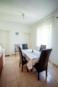 a dining room with a table and chairs at Virágos vendégház in Keszthely