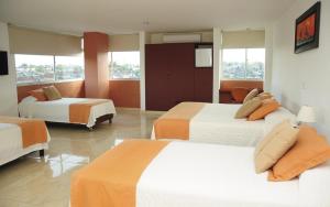 Postel nebo postele na pokoji v ubytování Hotel Hacaritama Colonial