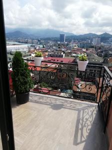 a balcony with two potted plants and a city at Daros apartment in Batumi