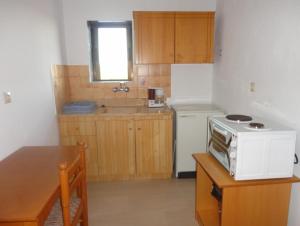 a kitchen with a white microwave on a table at Chris Apartments in Metamorfosi