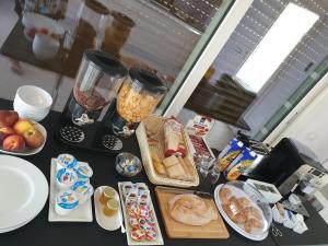 a table with a bunch of food on it at B&B L'EDEN DI CAPO BIANCO in Montallegro