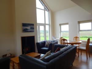 a living room with a couch and a fire place at The Chalet at Corvally in Portrush