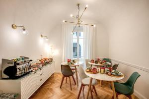 a dining room with two tables and chairs with food on them at Trastevere 2.0 in Rome