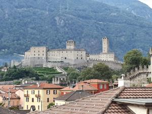 a castle on top of a mountain with buildings at Locanda Marco in Bellinzona