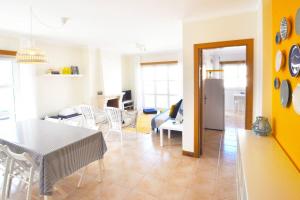 a kitchen and living room with a table and chairs at Casa Carapau in Ferrel