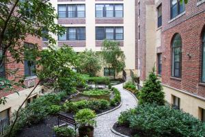 a courtyard with a garden in front of a building at Sleeps 6! 2 Bedrm, Gym, Close to Major Attractions in Philadelphia