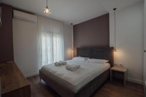 1 dormitorio con 1 cama grande y toallas. en Guesthouse Sara & Esi, en Korçë