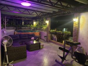uma sala de estar com um sofá e uma piscina em V Gostyah U Julii Guest House em Adler