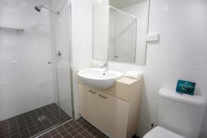 a bathroom with a sink and a shower and a toilet at Quest Palmerston - Darwin in Darwin