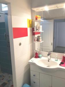 a bathroom with a sink and a mirror at Sarithea in Basse-Terre