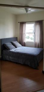 a large bed in a bedroom with a window at villa serena 4 Beds, 2 Bath in Rosarito +16 photos