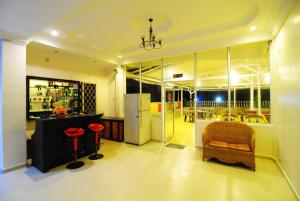 a living room with a refrigerator and a chair at Hotel Panorama in Tanjung Pinang