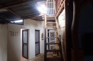 a room with a staircase in a building with a door at GRANDMA GUEST HOUSE including jungle Trek in Bukit Lawang