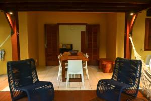 a dining room with a table and chairs at Apartamento Solar dos Peixes in Praia do Forte