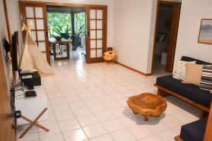 a living room with a couch and a coffee table at Apartamento Solar dos Peixes in Praia do Forte