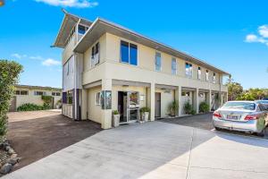 a building with a car parked in front of it at Waipu Cove Resort in Waipu