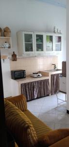 a kitchen with white cabinets and a counter top at Kalandra Guest House in Ponorogo