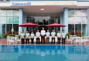 a group of men standing in front of a hotel at Annecy Hotel in Vang Vieng