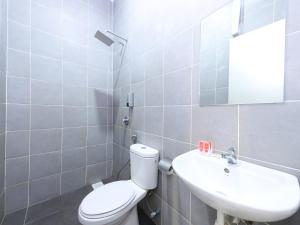 a bathroom with a white toilet and a sink at Hotel Seri Rembau in Rembau