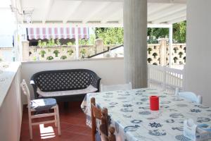 een eetkamer met een tafel en een balkon bij Casa Carapelle Grazioso villino alto Salento in Torre Canne